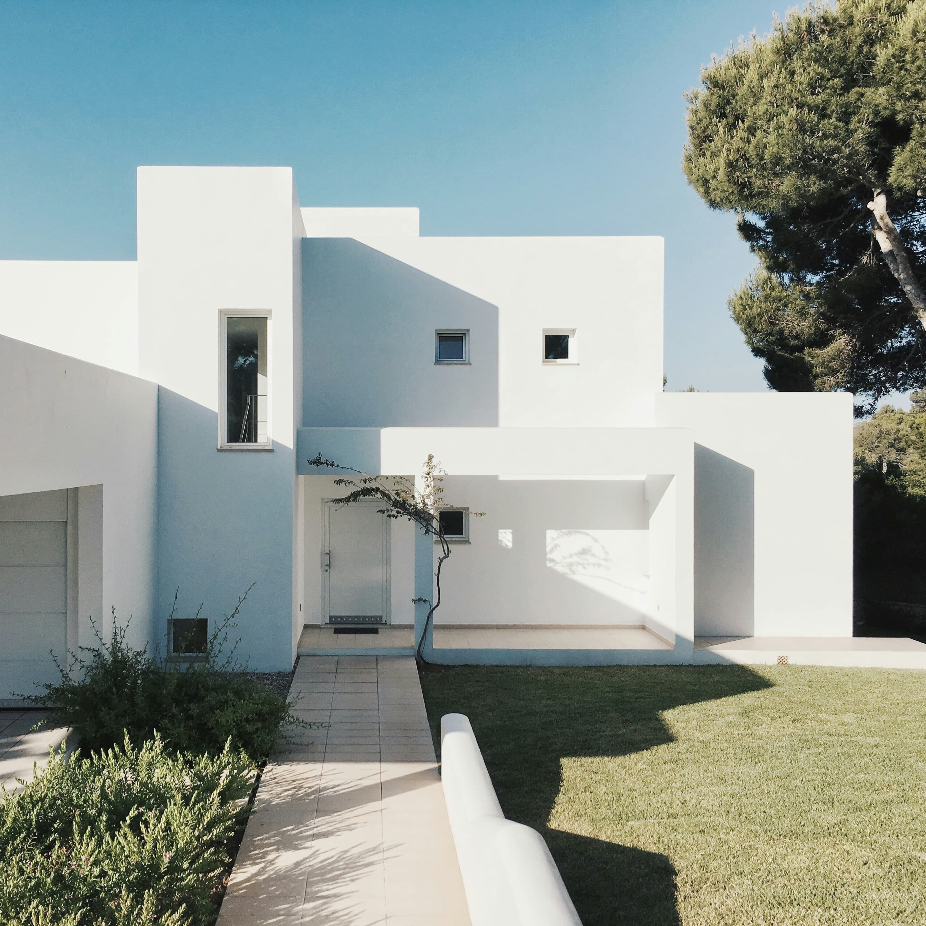 A modern villa surrounded with a green garden